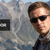 man wearing carbon fiber polarized sunglasses cycling outdoors