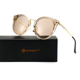 Oversized cat-eye sunglasses with light brown UV400 lenses resting on a SUNGAIT box