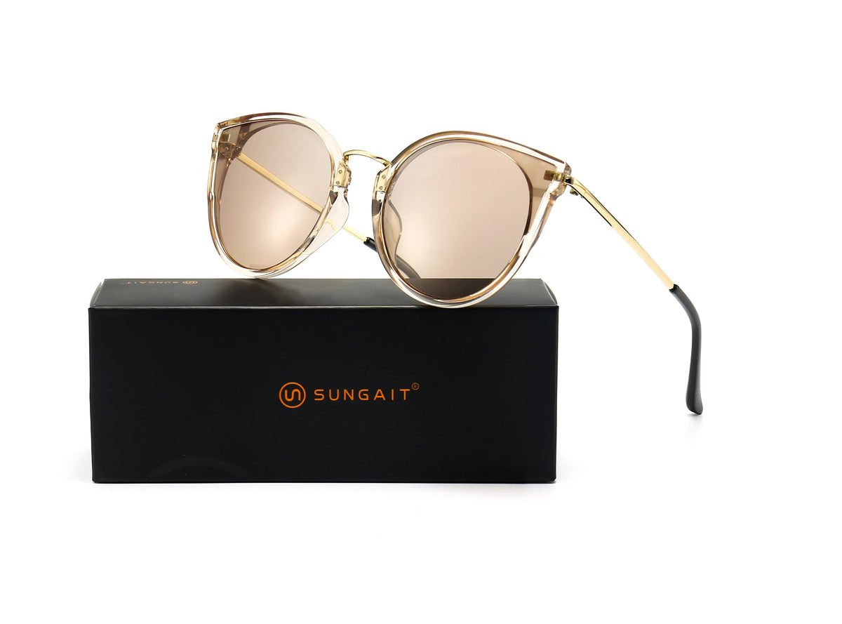 Oversized cat-eye sunglasses with light brown UV400 lenses resting on a SUNGAIT box